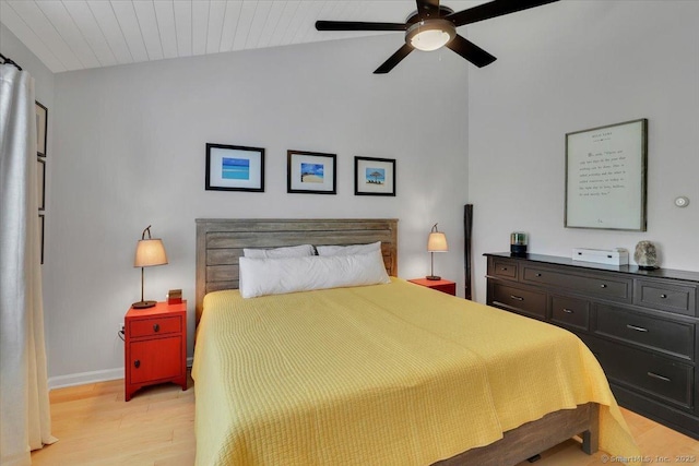 bedroom with light wood-style floors, baseboards, ceiling fan, and vaulted ceiling