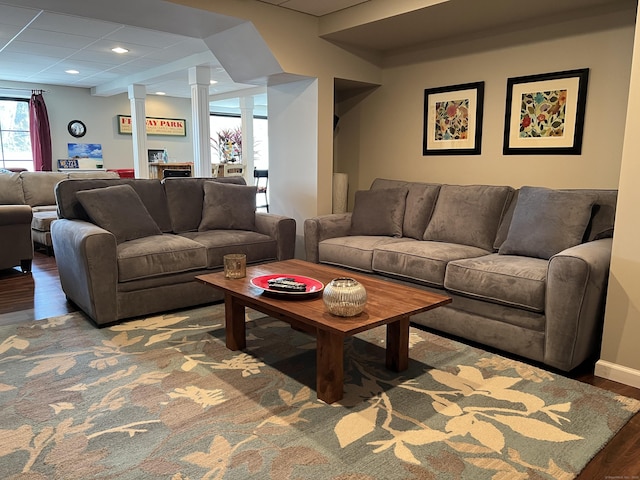living room featuring decorative columns, recessed lighting, and wood finished floors