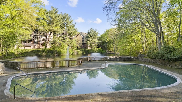 view of pool featuring a water view