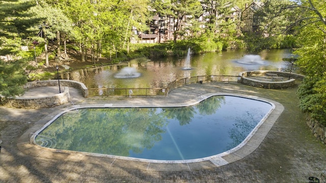 view of pool with a water view