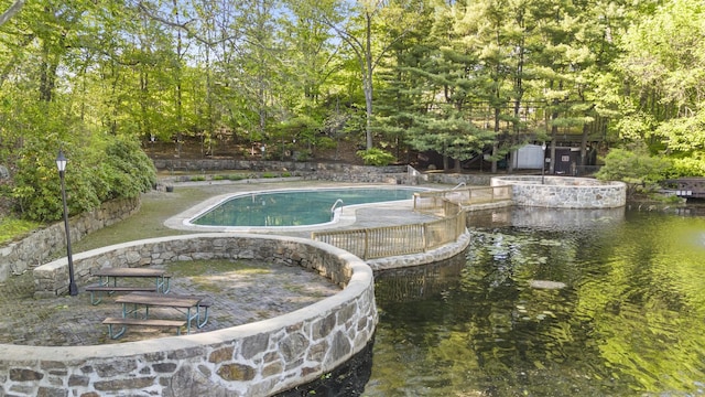 swimming pool with view of scattered trees