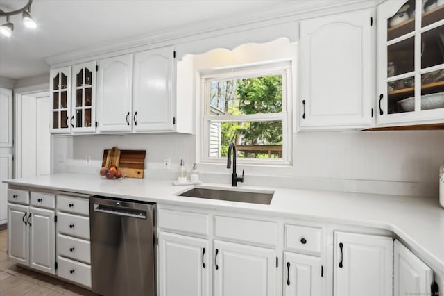 kitchen with glass insert cabinets, light countertops, white cabinetry, a sink, and dishwasher