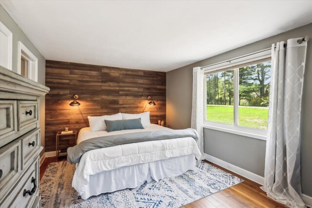 bedroom with baseboards and wood finished floors