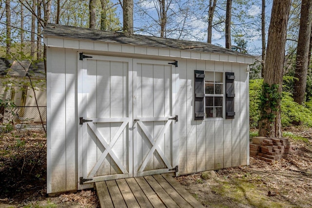 view of shed featuring fence