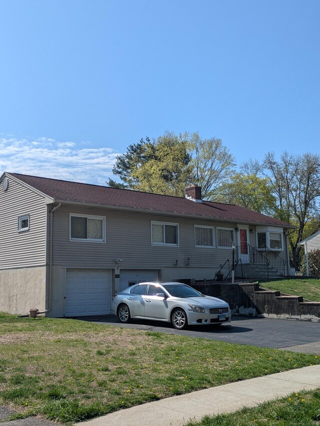264 Timber Ln, Cheshire, CT 06410 - view of front of home with a garage, a chimney, a front lawn, and aphalt driveway