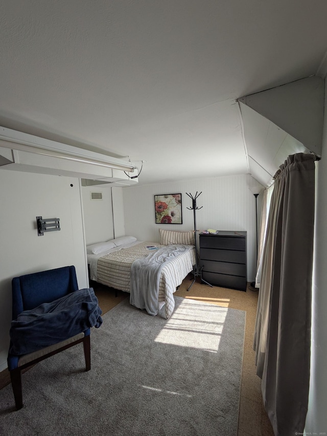 bedroom featuring carpet floors and vaulted ceiling
