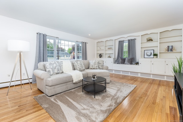 living area featuring baseboard heating and wood finished floors