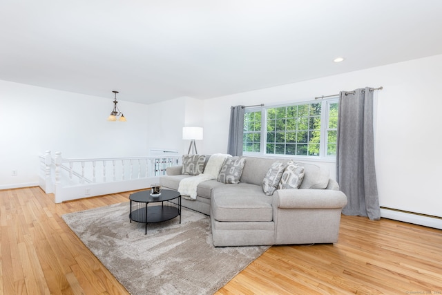 living room with wood finished floors, a baseboard heating unit, and recessed lighting