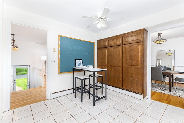 dining space with ceiling fan, light tile patterned floors, and baseboard heating
