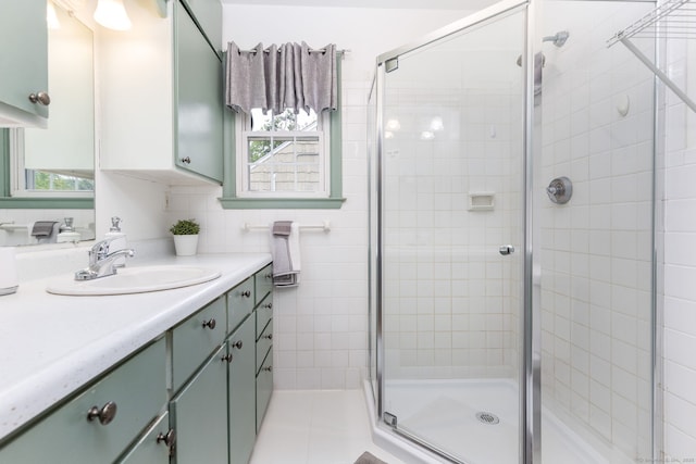 bathroom featuring a shower stall and vanity
