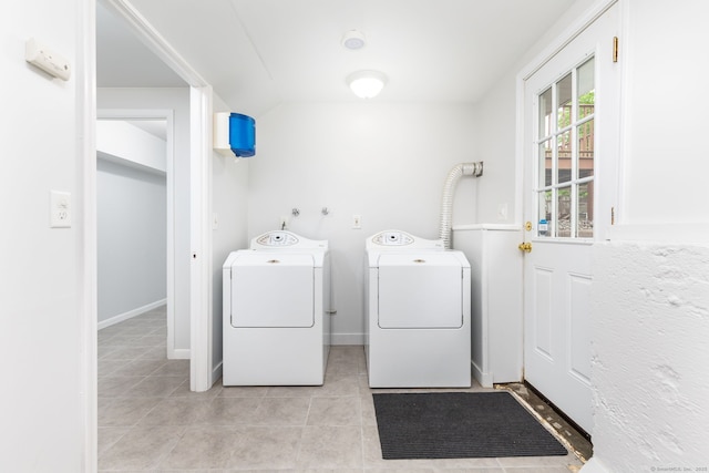 washroom with independent washer and dryer and light tile patterned flooring