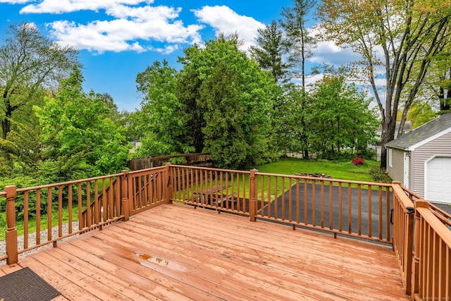 deck featuring an outdoor structure and a yard