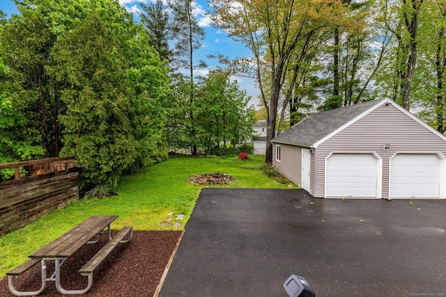 detached garage with view of scattered trees