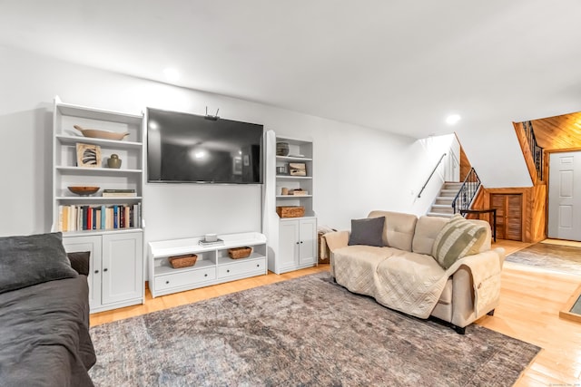 living room featuring recessed lighting, stairway, and light wood-type flooring