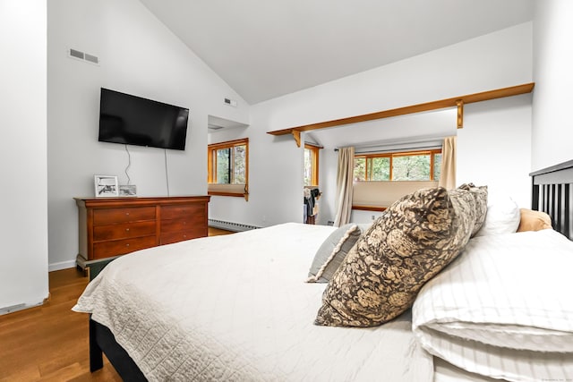 bedroom with high vaulted ceiling, baseboard heating, visible vents, and wood finished floors