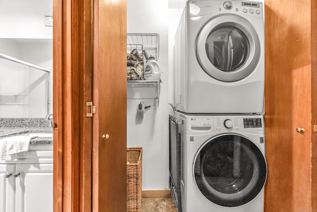 laundry room with laundry area and stacked washer / dryer