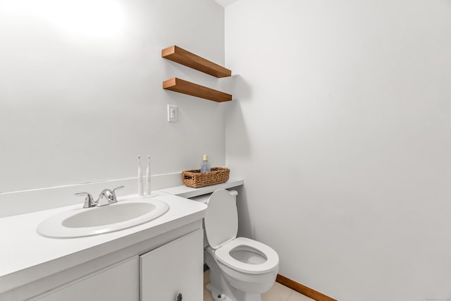 bathroom featuring vanity, toilet, and tile patterned flooring