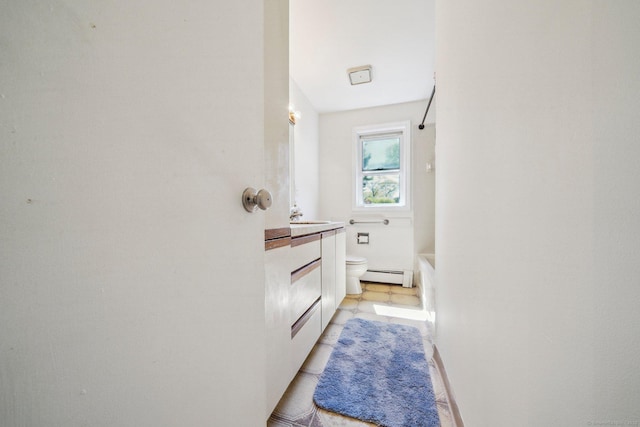 full bathroom featuring toilet, a baseboard radiator, and vanity