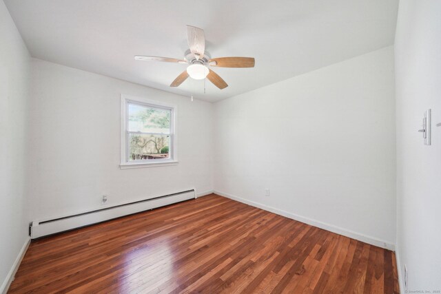 empty room featuring wood finished floors, a ceiling fan, baseboards, and a baseboard heating unit