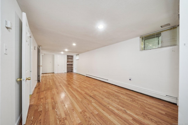 interior space with recessed lighting, a baseboard radiator, light wood-style flooring, and baseboards