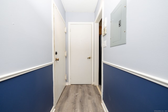 corridor featuring electric panel and wood finished floors