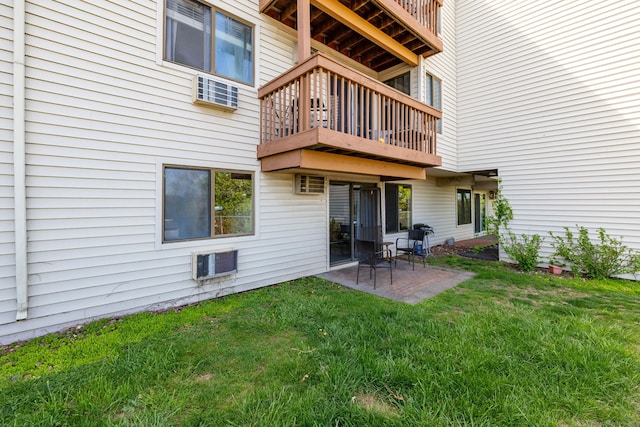 back of house featuring a yard, a patio area, and a balcony