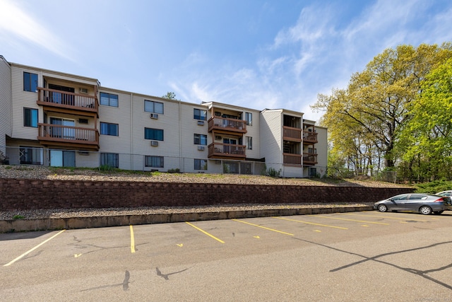 view of building exterior with uncovered parking
