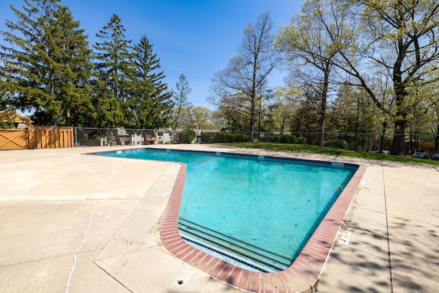view of swimming pool featuring a fenced in pool, fence, and a patio