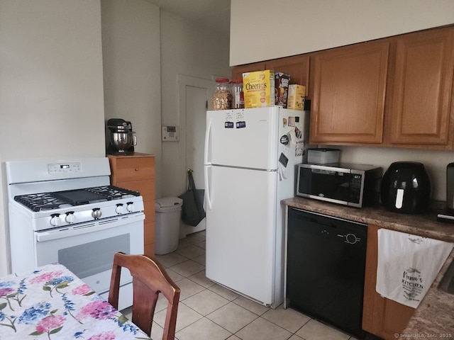 248-250 Howard Ave, New Haven, CT 06519 - kitchen featuring white appliances, light tile patterned floors, and brown cabinetry