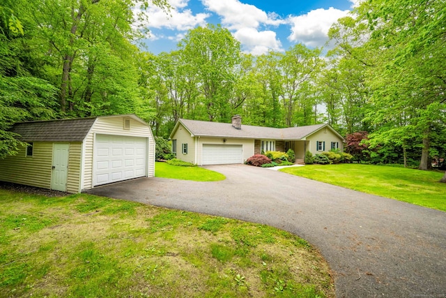 26 Converse Rd, Bolton, CT 06043 - view of front of property with a chimney, an outbuilding, a front yard, and a detached garage