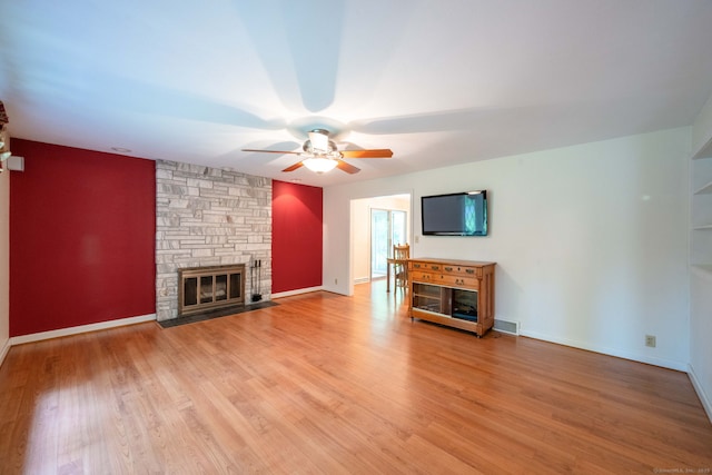 26 Converse Rd, Bolton, CT 06043 - unfurnished living room with a fireplace, a ceiling fan, light wood-type flooring, and baseboards