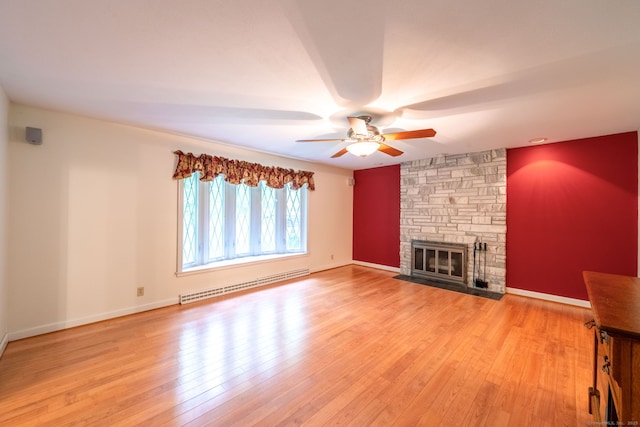 26 Converse Rd, Bolton, CT 06043 - unfurnished living room with a baseboard heating unit, a ceiling fan, light wood-style floors, a stone fireplace, and baseboards