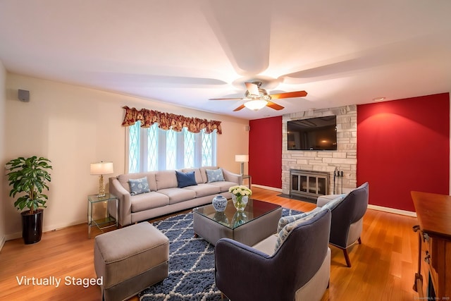 26 Converse Rd, Bolton, CT 06043 - living area featuring ceiling fan, wood finished floors, a stone fireplace, and baseboards