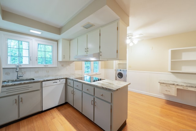 26 Converse Rd, Bolton, CT 06043 - kitchen featuring white dishwasher, a sink, black electric cooktop, washer / dryer, and under cabinet range hood