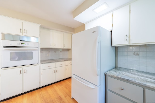 26 Converse Rd, Bolton, CT 06043 - kitchen with white appliances, tasteful backsplash, light wood finished floors, and white cabinetry