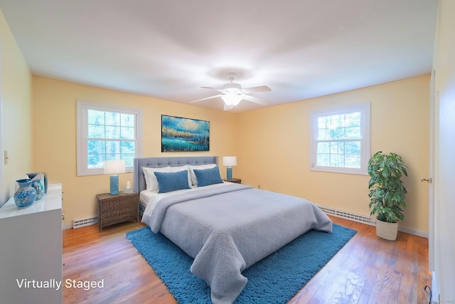 26 Converse Rd, Bolton, CT 06043 - bedroom featuring a baseboard heating unit, multiple windows, light wood-style floors, and baseboards