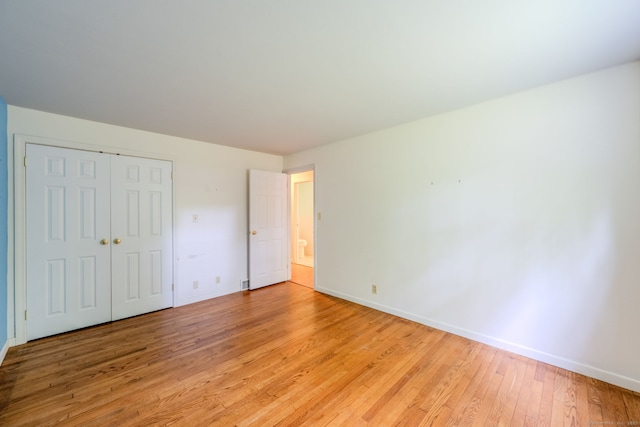 26 Converse Rd, Bolton, CT 06043 - unfurnished bedroom with light wood-type flooring, baseboards, and a closet