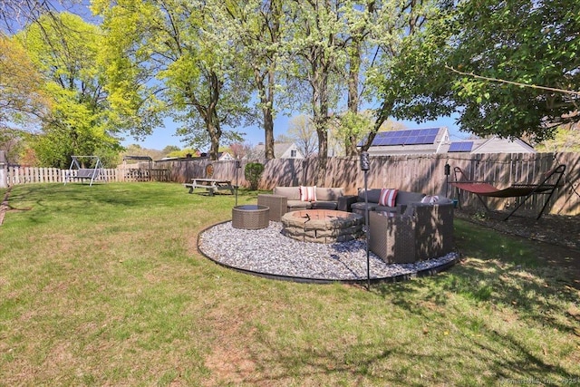 view of yard featuring a fenced backyard and an outdoor living space with a fire pit