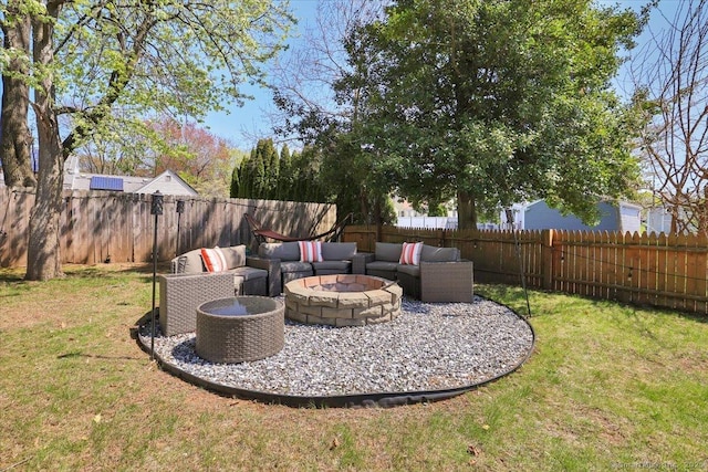 view of yard with a fenced backyard and an outdoor living space with a fire pit