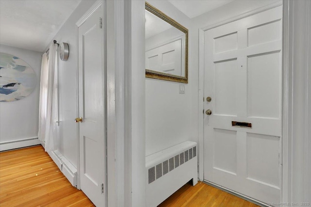 interior space with radiator heating unit, light wood finished floors, and a baseboard radiator