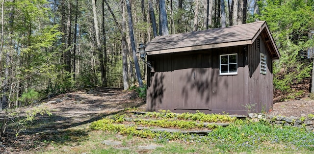 view of shed with a view of trees