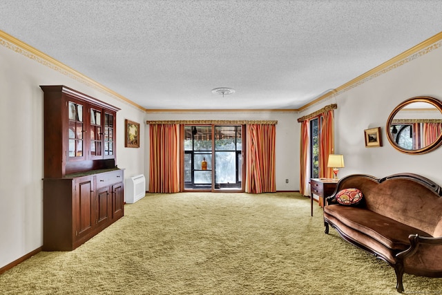 living area with baseboards, ornamental molding, a textured ceiling, and carpet flooring
