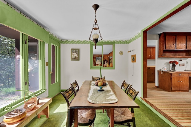 dining space featuring light colored carpet and plenty of natural light