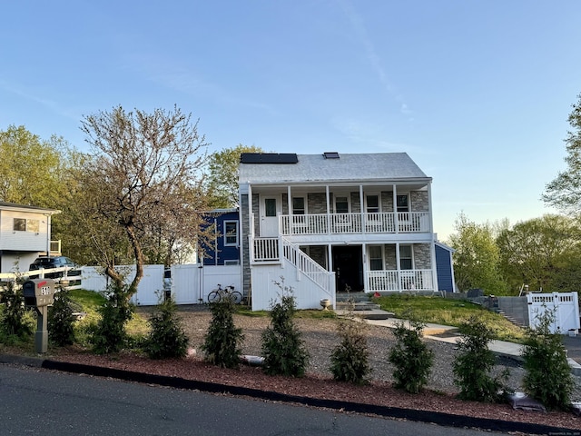 310 Sentinel Hill Rd, Derby, CT 06418 - view of front facade featuring fence, a gate, a porch, stairway, and solar panels