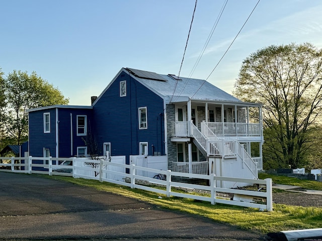 310 Sentinel Hill Rd, Derby, CT 06418 - view of front of home with covered porch, a fenced front yard, solar panels, and stairway