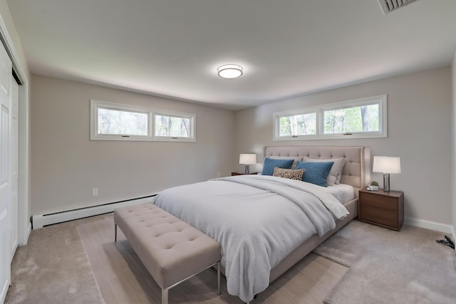 1037 Bartholomew Rd, Middletown, CT 06457 - bedroom featuring a baseboard radiator, light colored carpet, a closet, and baseboards