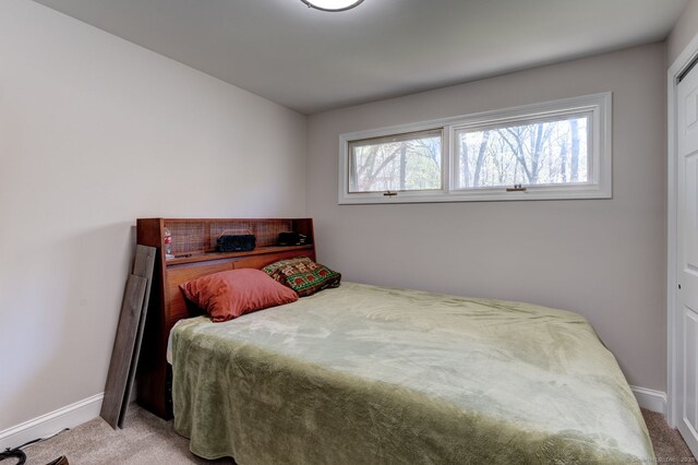 carpeted bedroom featuring baseboards