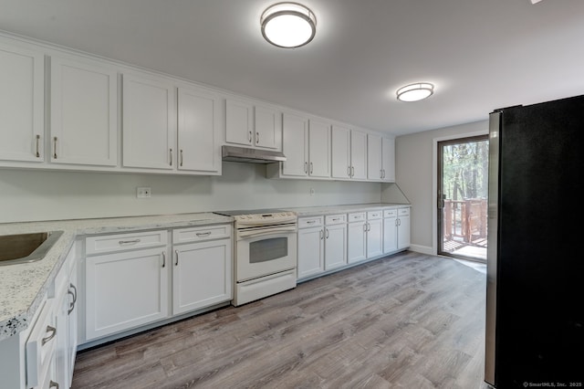 kitchen with white electric range, freestanding refrigerator, under cabinet range hood, and white cabinets