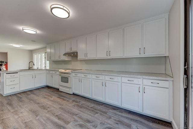kitchen featuring under cabinet range hood, electric range, and white cabinetry