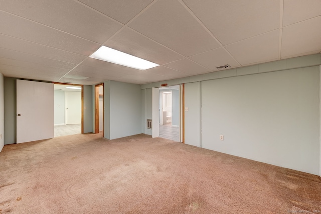 unfurnished room featuring carpet flooring, visible vents, and a drop ceiling